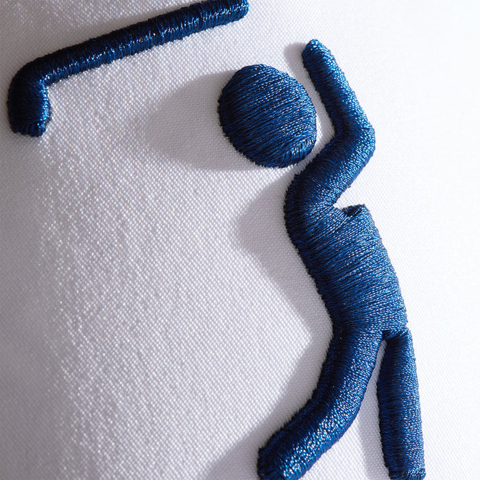 Close-up of the Bogeyman - White/Navy Snapback Performance Golf Hat, featuring a blue embroidered stylized figure with a circular head, curved arm, and angled leg—resembling someone bowling—stitched on sweat stain resistant white fabric.