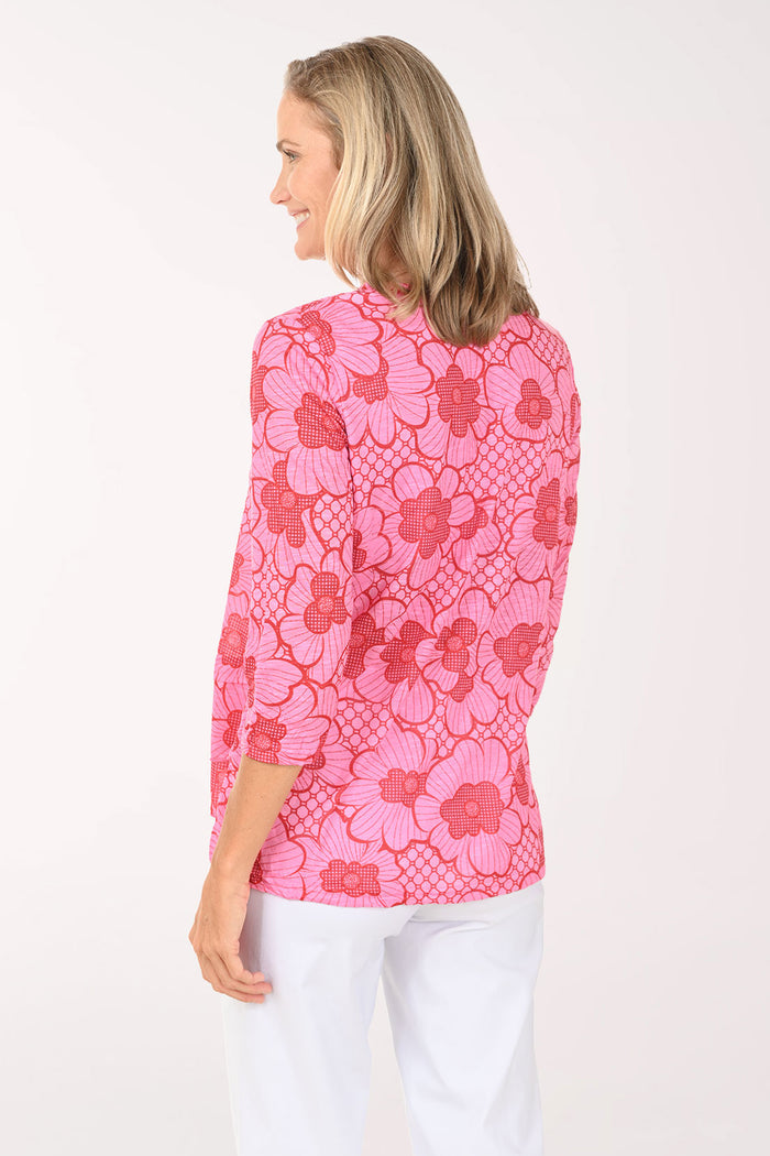 Woman wearing a pink 3/4 sleeve v-neck top