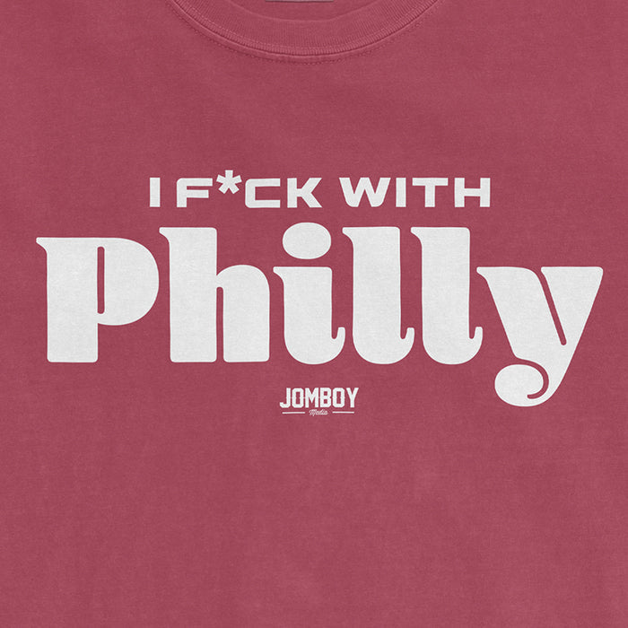 Pink Comfort Colors T-shirt with white text that reads "I F*CK WITH Philly" and a small "JOMBOY Media" logo underneath.