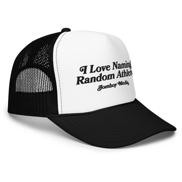 Black and white trucker hat with embroidered text: "I Love Naming Random Athletes | Jomboy Media.