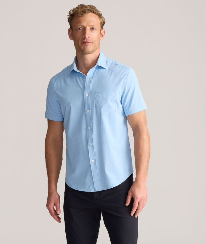 Model is wearing UNTUCKit Performance Gironde Shirt in light blue.