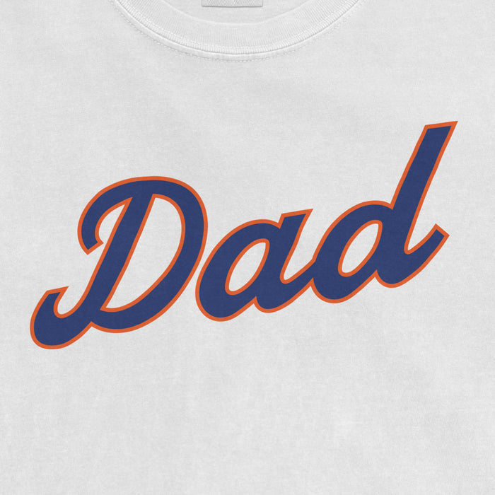 Close-up of a white T-shirt with the word "Dad" in bold navy blue script outlined in orange.