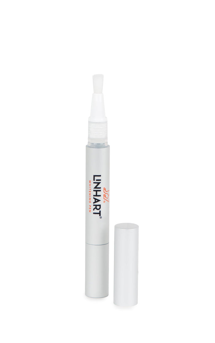 Whitening Pen | LINHART with a brush applicator and cap removed, designed for precise teeth whitening in a sleek, silver skincare tool for enhanced wellness.