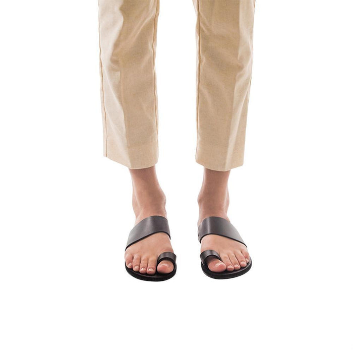Model wearing Abra black, handmade leather slide sandals with toe loop
