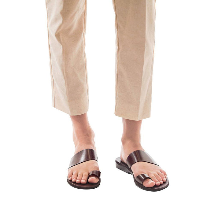 Model wearing Abra brown, handmade leather slide sandals with toe loop