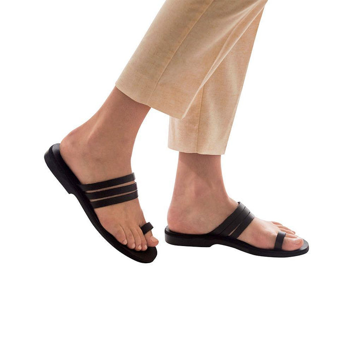 Model wearing Angela black, handmade leather slide sandals with toe loop
