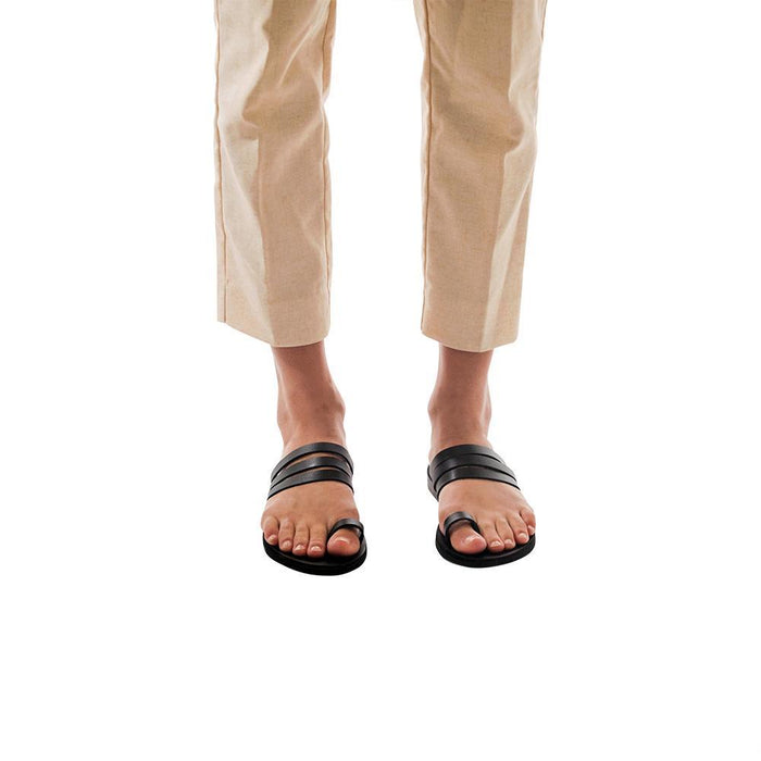 Model wearing Angela black, handmade leather slide sandals with toe loop