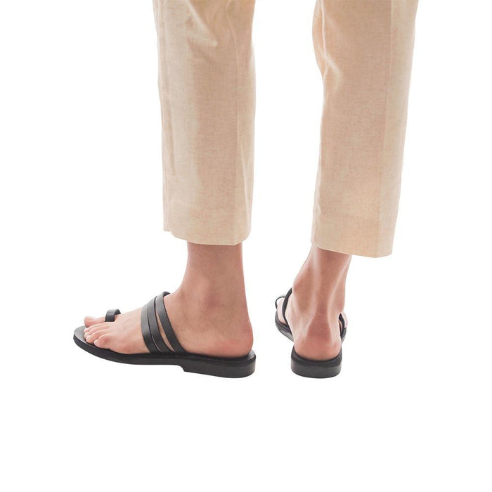 Model wearing Angela black, handmade leather slide sandals with toe loop