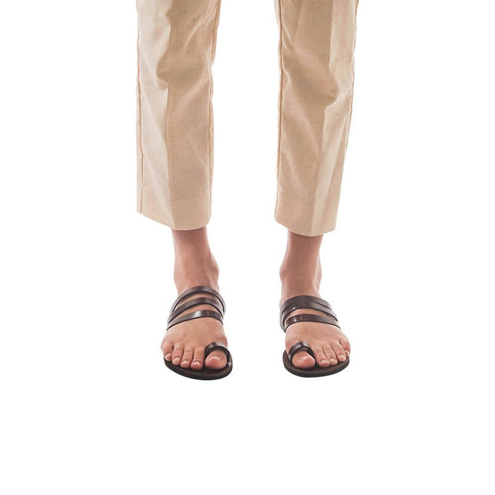 Model wearing Angela brown, handmade leather slide sandals with toe loop