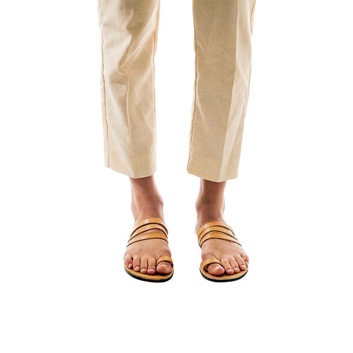 Model wearing Angela tan, handmade leather slide sandals with toe loop
