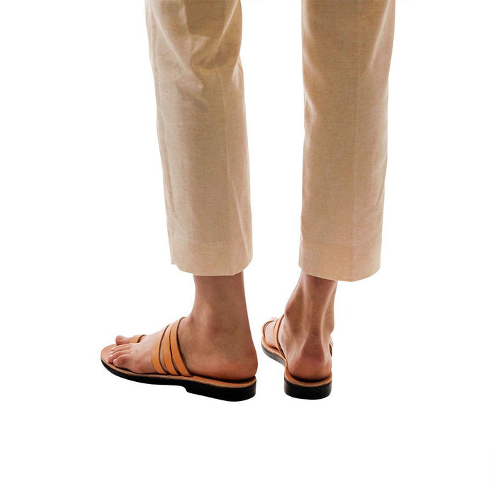 Model wearing Angela tan, handmade leather slide sandals with toe loop