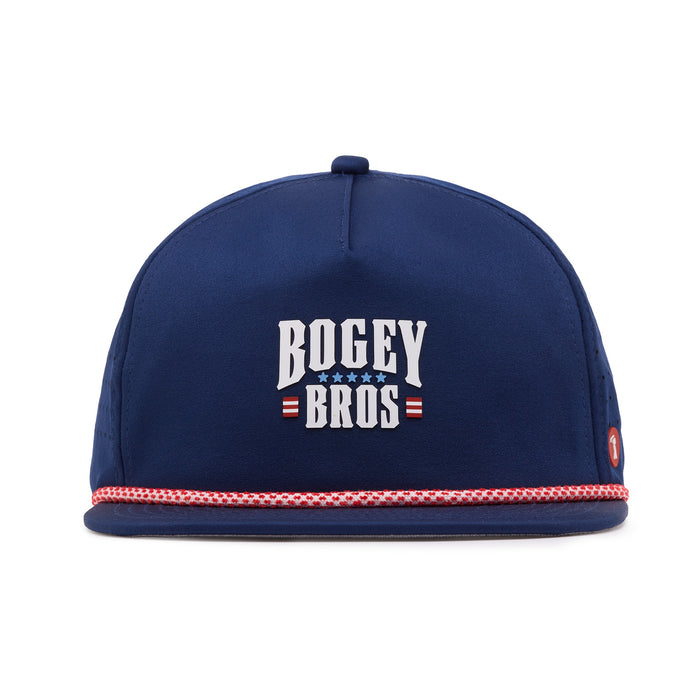 A navy blue baseball cap with BOGEY BROS written in bold white letters, flanked by three white stars and red stripes. The hat features a red and white braided band above the brim and a small circular logo on the right side.