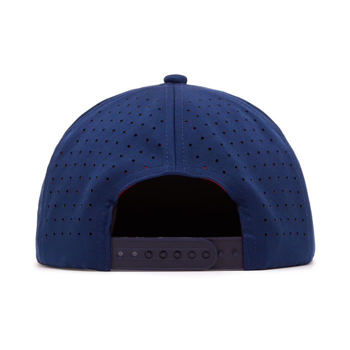 A navy blue snapback cap viewed from the back. The cap features small ventilation holes across the surface and has an adjustable black plastic snap closure at the bottom center. The crown is rounded and the interior is partially visible through the opening.