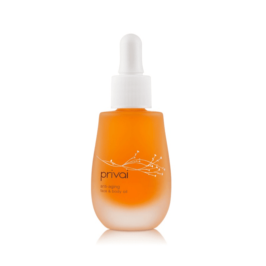 A frosted glass bottle with a white dropper cap containing orange Anti-Aging Face & Body Oil | Privai with a minimalist floral design on the label.
