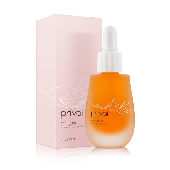 Bottle of Anti-Aging Face & Body Oil | Privai with a dropper, placed next to its light pink packaging, designed for skincare and body care wellness.