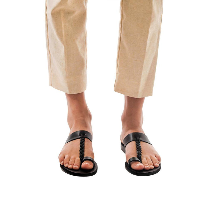 Model wearing Ara black, handmade leather slide sandals with toe loop