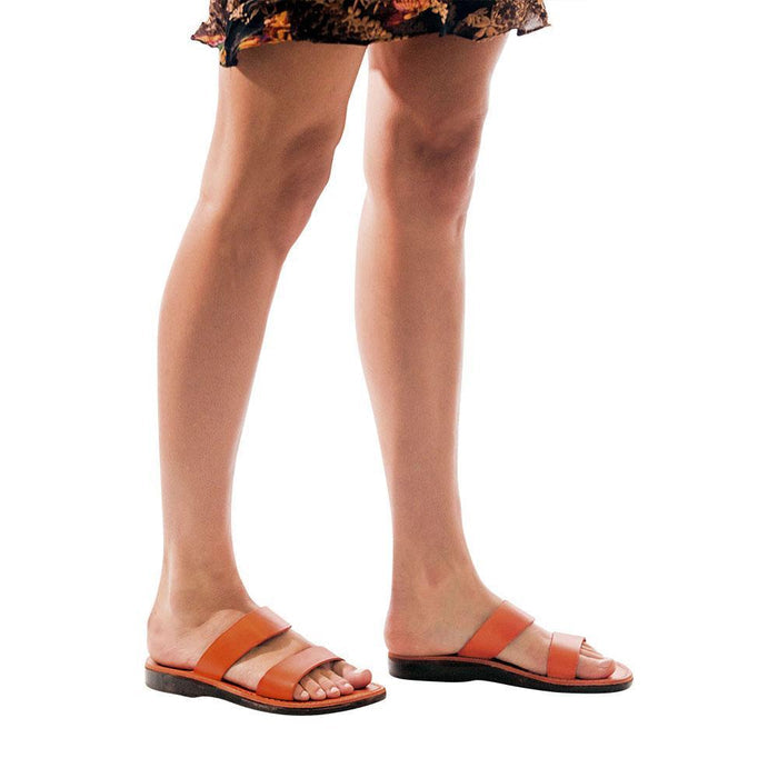 Model wearing Aviv orange, handmade leather slide sandals