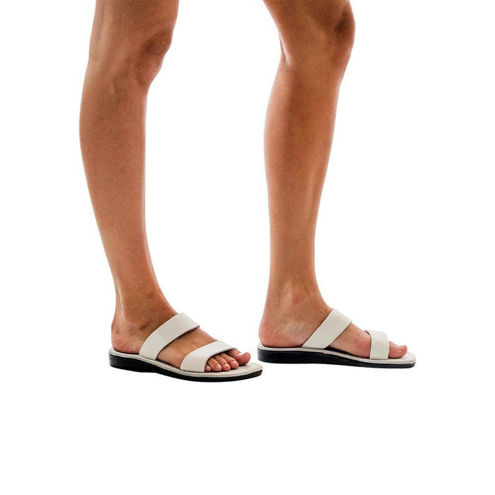 Model wearing Aviv white, handmade leather slide sandals
