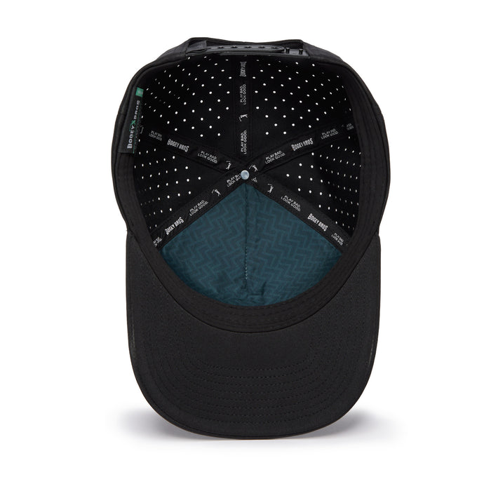 The Bogeyman - Black/Black Performance Golf Hat is a snapback cap shown from above. The interior features sweat stain-resistant material with small white dots, black sweatbands with white text, and a blue-green zigzag near the front.