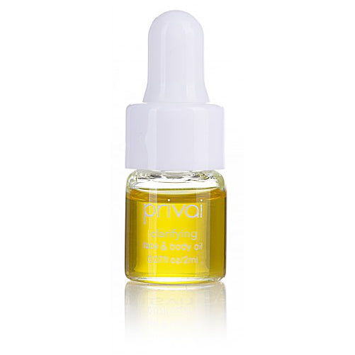 Small clear glass bottle with white dropper cap containing yellow oil labeled Clarifying Face & Body Oil | Privai for skincare and body care wellness.
