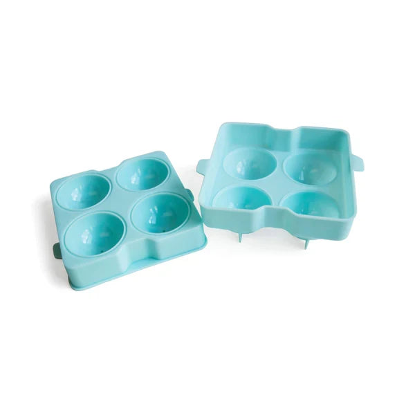 A blue ice sphere tray filled with four spherical ice molds for cocktails on white background.