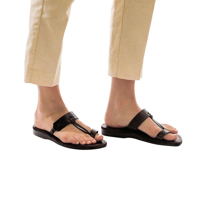 Model wearing David black, handmade leather slide sandals with toe loop