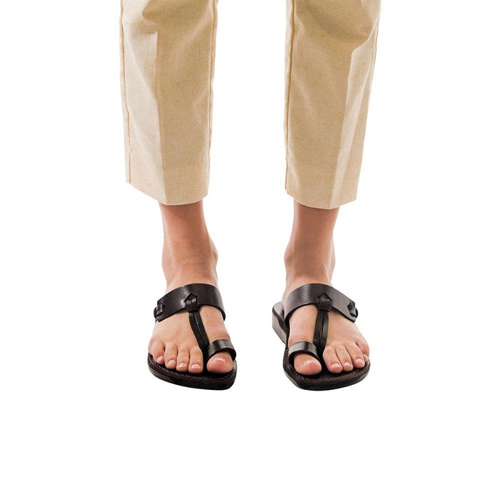 Model wearing David black, handmade leather slide sandals with toe loop