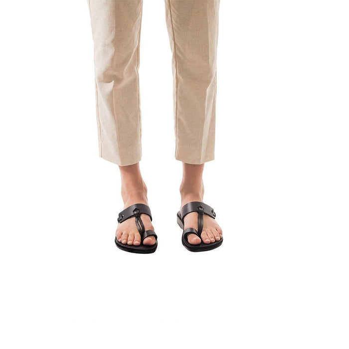 Model wearing David brown, handmade leather slide sandals with toe loop