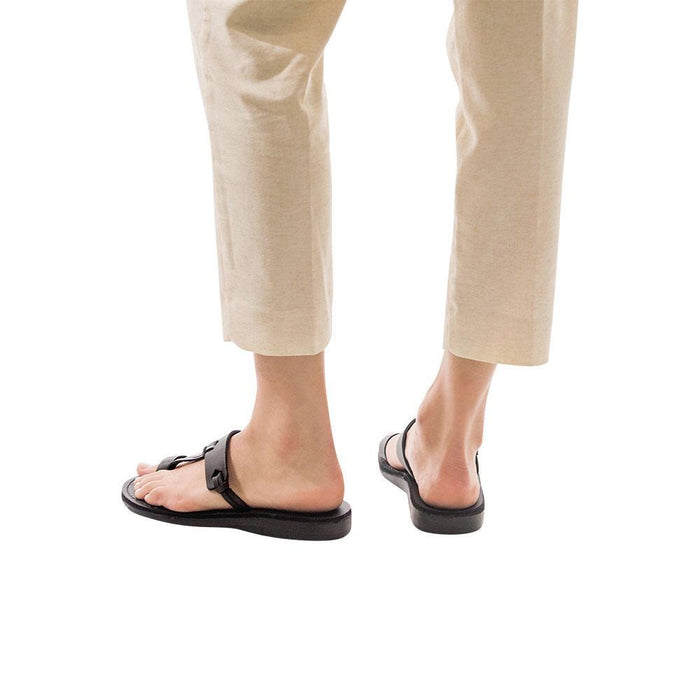 Model wearing David brown, handmade leather slide sandals with toe loop