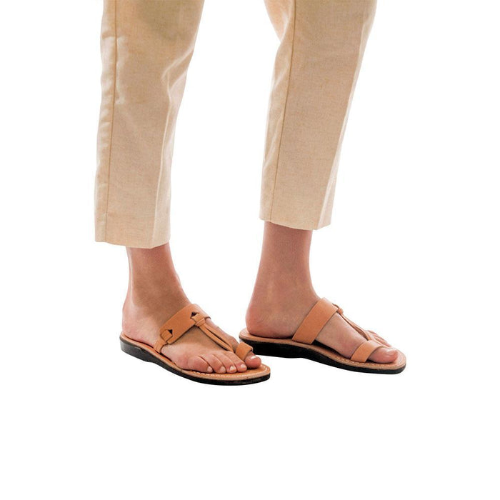 Model wearing David tan, handmade leather slide sandals with toe loop