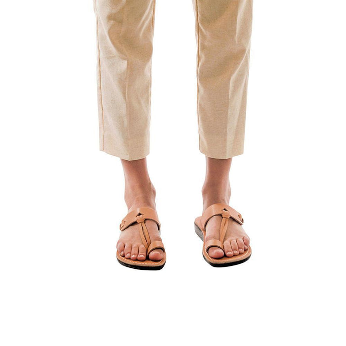 Model wearing David tan, handmade leather slide sandals with toe loop