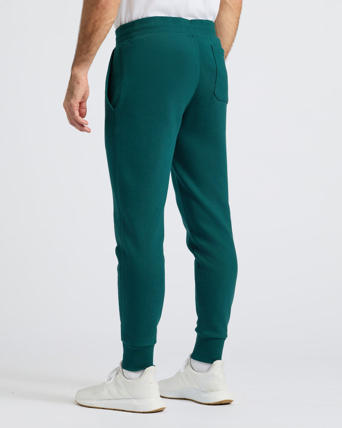 Deep Emerald Fleece French Terry Joggers with sneakers, showcasing comfort fit.