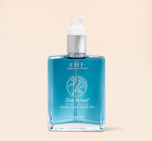 Dew Ritual® Triple Lipid Body Oil | Farmhouse Fresh in a clear glass bottle with blue body oil and a white pump dispenser, designed for skincare and body care wellness.