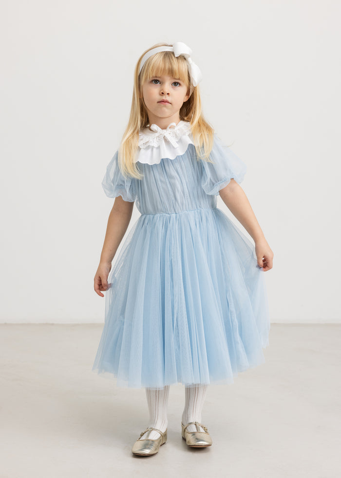 Fairy dress in light blue tulle with a ruffled collar, gathered waist, and puff sleeves.
