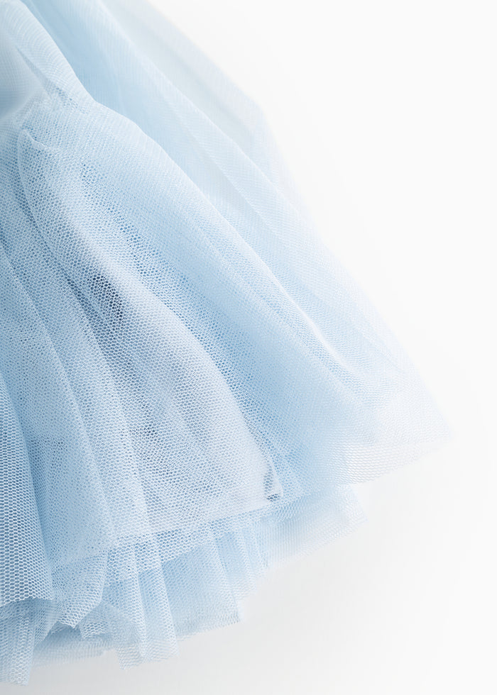 Fairy dress in light blue tulle, close-up of layers and wavy folds at the bottom.