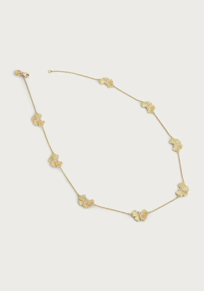 18K gold butterfly station necklace laid flat showing station design