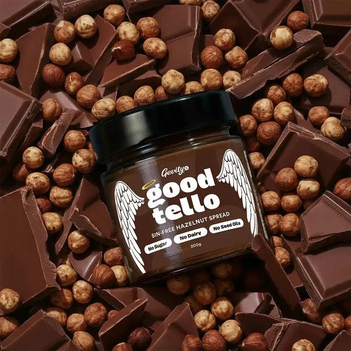 Jar of 'good tello' hazelnut spread surrounded by chocolate bars and nuts