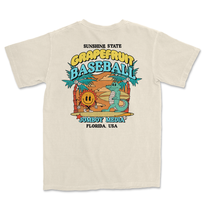 Comfort Colors tee featuring a colorful grapefruit baseball design with cartoon characters, palm trees, and Florida-themed text.