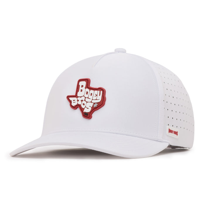 A white baseball cap with a red patch in the shape of Texas and the words Bogey Bros on the front. The side of the cap features small ventilation holes and a small red label. The cap is viewed from a front left angle.