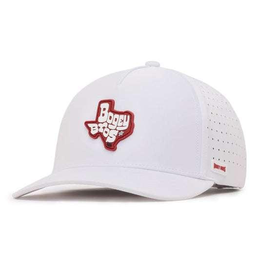 A white baseball cap with a red patch in the shape of Texas and the words Bogey Bros on the front. The side of the cap features small ventilation holes and a small red label. The cap is viewed from a front left angle.