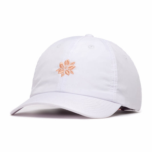 The In Bloom - Dad Hat is a white, unstructured cap with a curved brim and peach embroidered flower at the front. Made from performance material, it features stitched eyelets for ventilation and offers a relaxed fit.