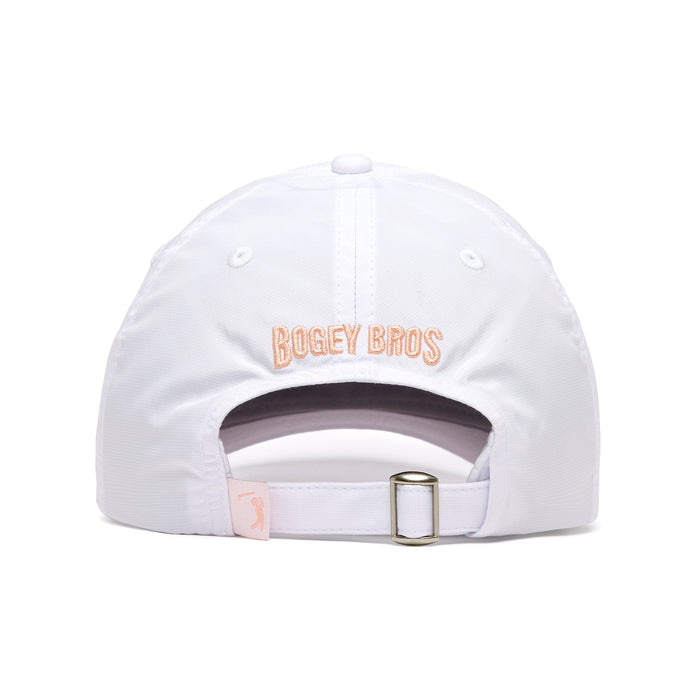 The In Bloom - Dad Hat is a white cap shown from the back with "BOGEY BROS" embroidered in light pink above the adjustable strap. It features stitched eyelets for ventilation and a soft sweatband for comfort.