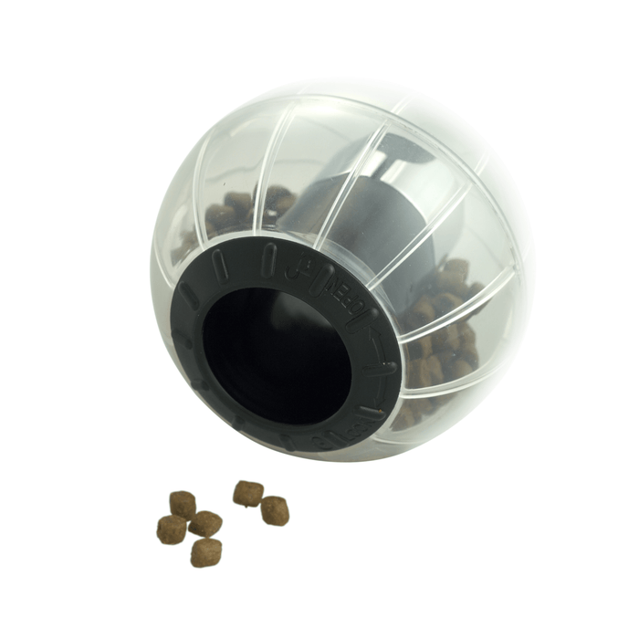 White background with a Kruuse Catmosphere treat dispenser, with a black trim and transparent body with cat treats visible inside.