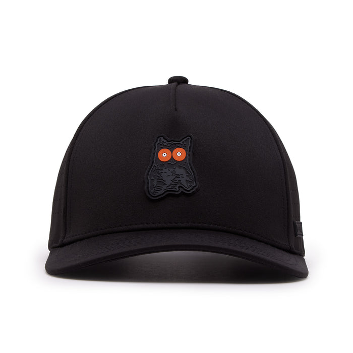The Night Owl - Performance Golf Hat - Snapback is a black cap with a small cartoon black owl patch with bright orange eyes above the brim, made from sweat stain resistant material with a curved bill and visible stitching on white background.