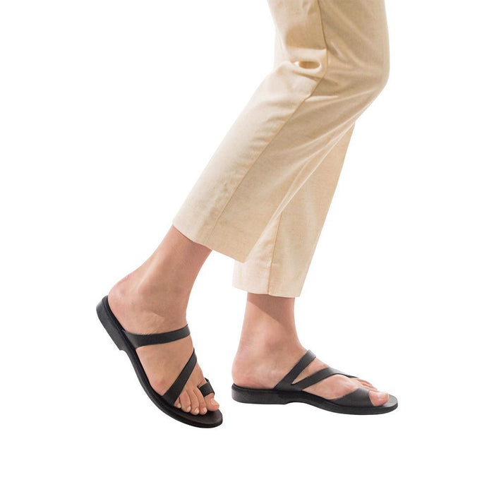 Model wearing Noah black, handmade leather slide sandals with toe loop