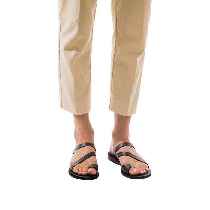 Model wearing Noah black, handmade leather slide sandals with toe loop