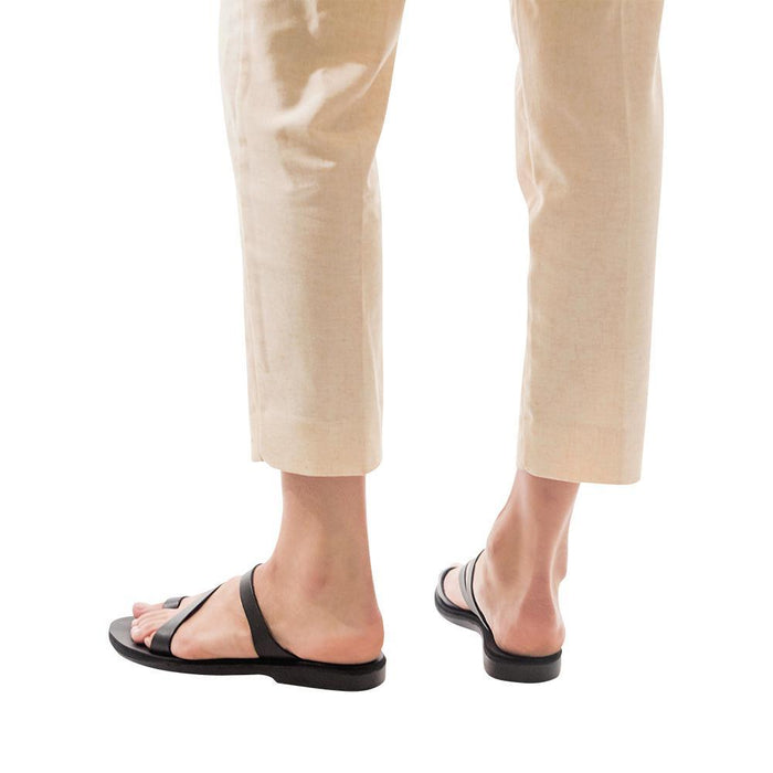 Model wearing Noah black, handmade leather slide sandals with toe loop