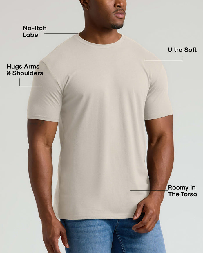 Man wearing an Oatmeal Tall Straight Hem Crew Neck T-Shirt that fits snugly around arms and shoulders with a roomy torso, featuring a no-itch label and ultra soft fabric.