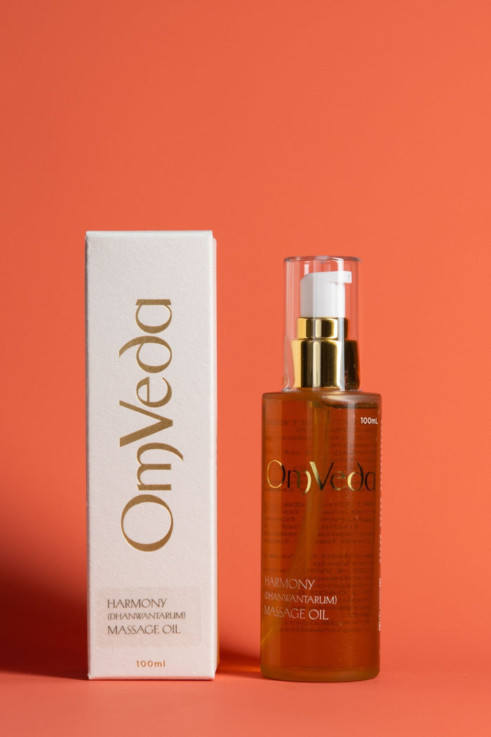 OmVeda Harmony body oil 100 ml bottle with gold pump and amber liquid, plus box