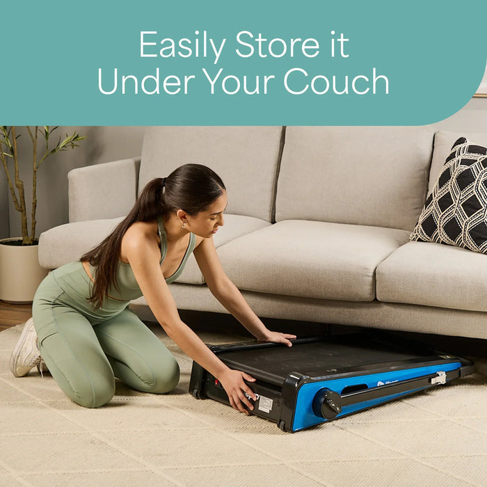 Woman kneeling to slide the folded PacerMini treadmill under a couch, with text reading Easily Store It Under Your Couch.